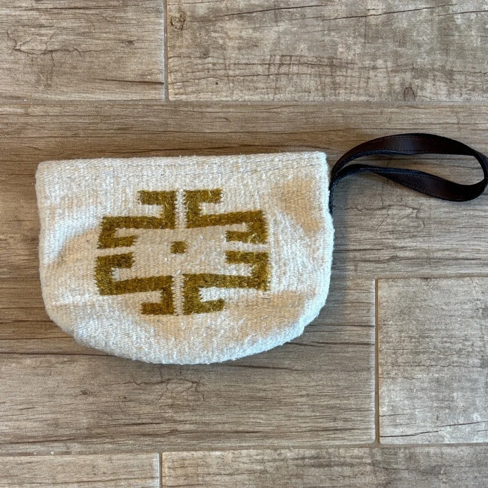 Handmade, one of a kind hundred percent wool clutch with leather wrist band.